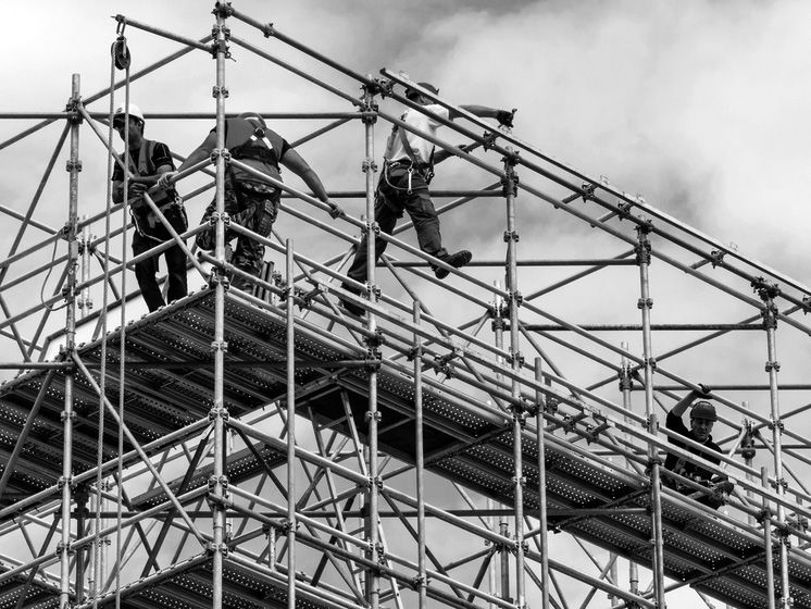 Photo of construction workers on scaffolding