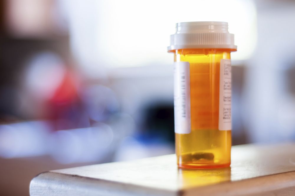 Empty prescription drug bottle on a counter